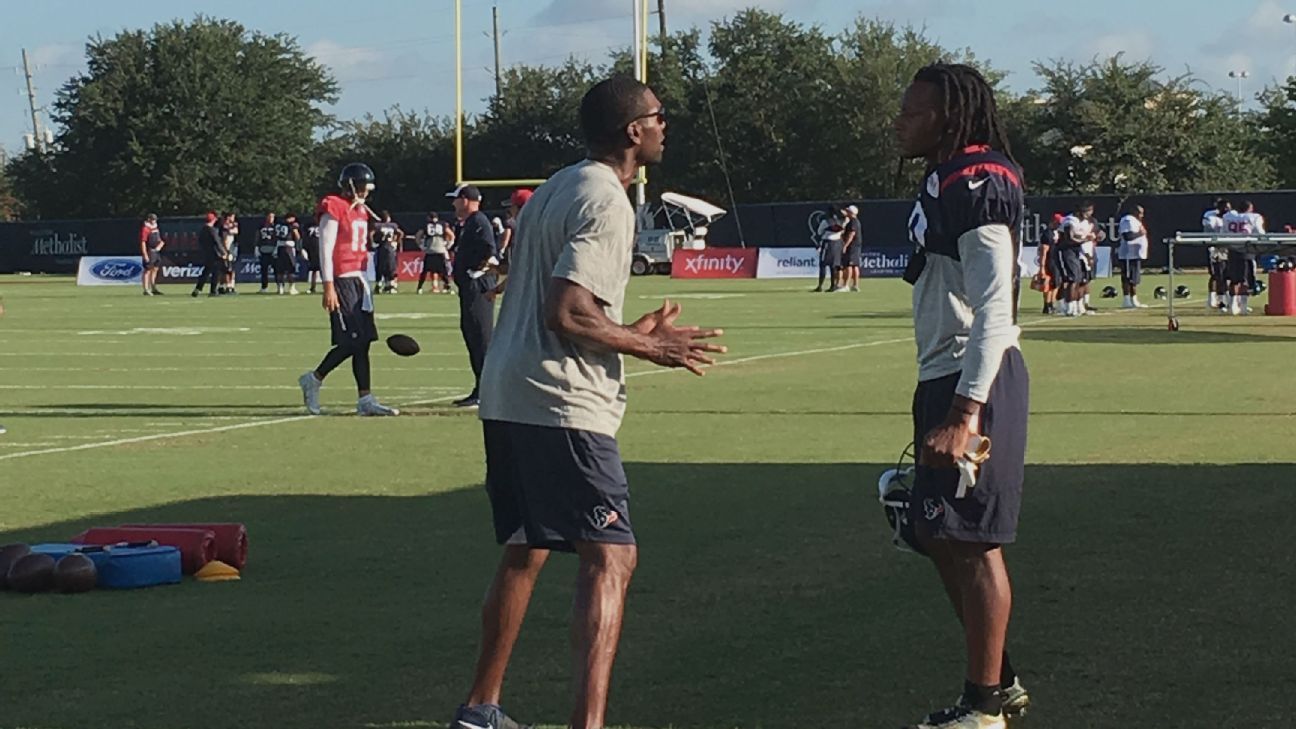 Randy Moss works with receiver DeAndre Hopkins at Texans' practice