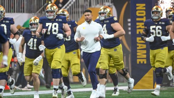 Notre Dame's coach Marcus Freeman on the field during a game.