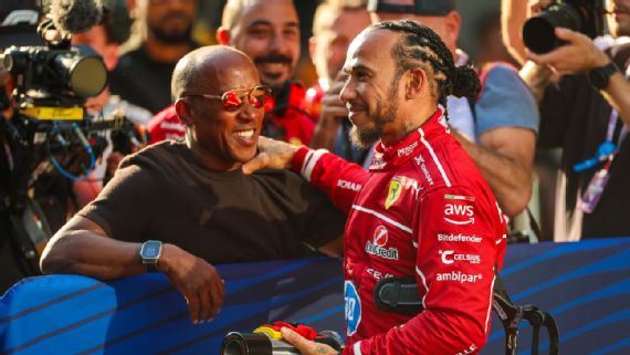 Lewis Hamilton celebrates with his father