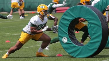 Green Bay Packers' AJ Dillon crushes a watermelon with his legs