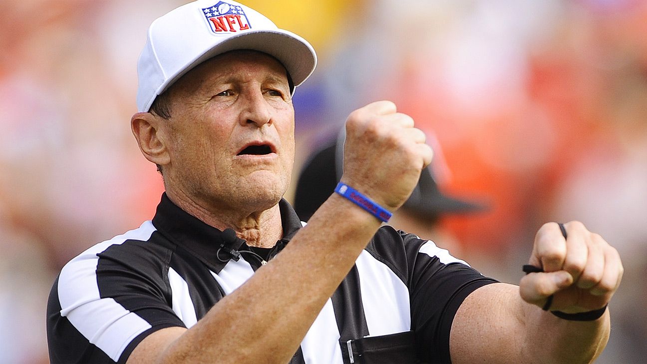 Portrait of NFL referee Ed Hochuli gesturing the personal foul