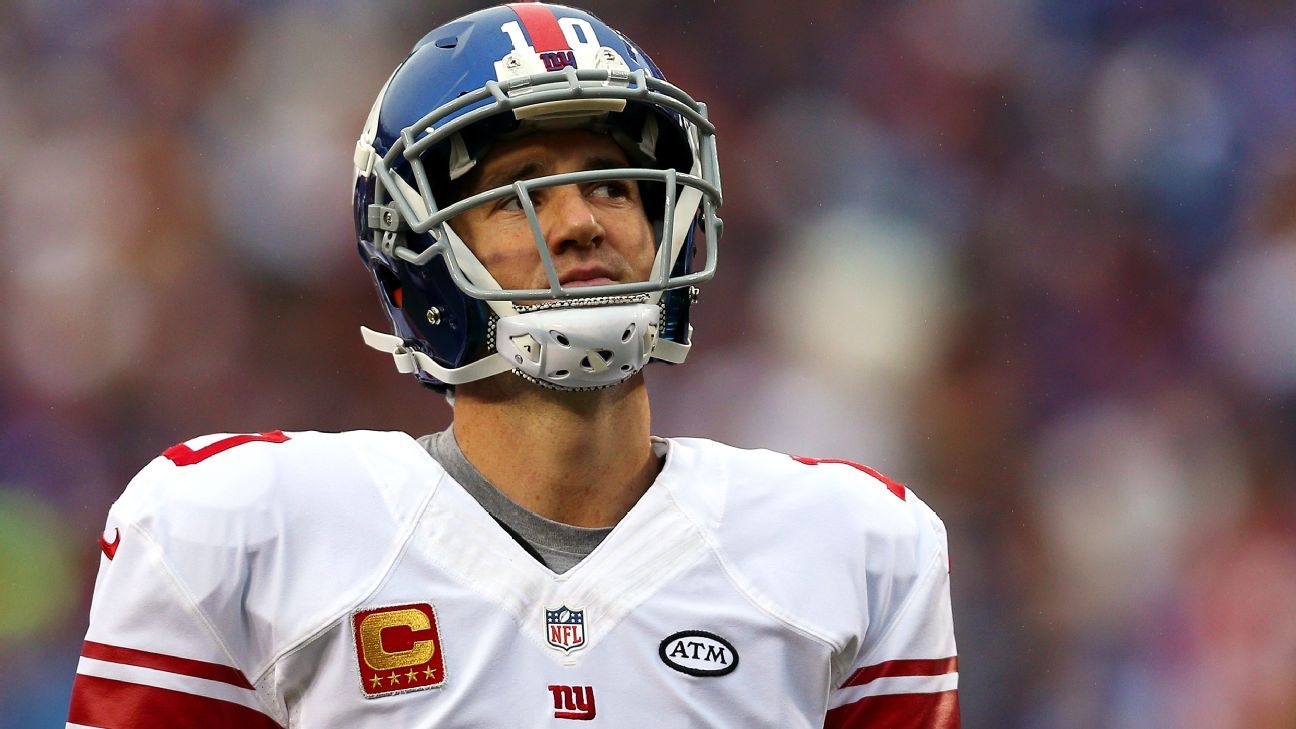 New York Giants quarterback Eli Manning gets face masked in the