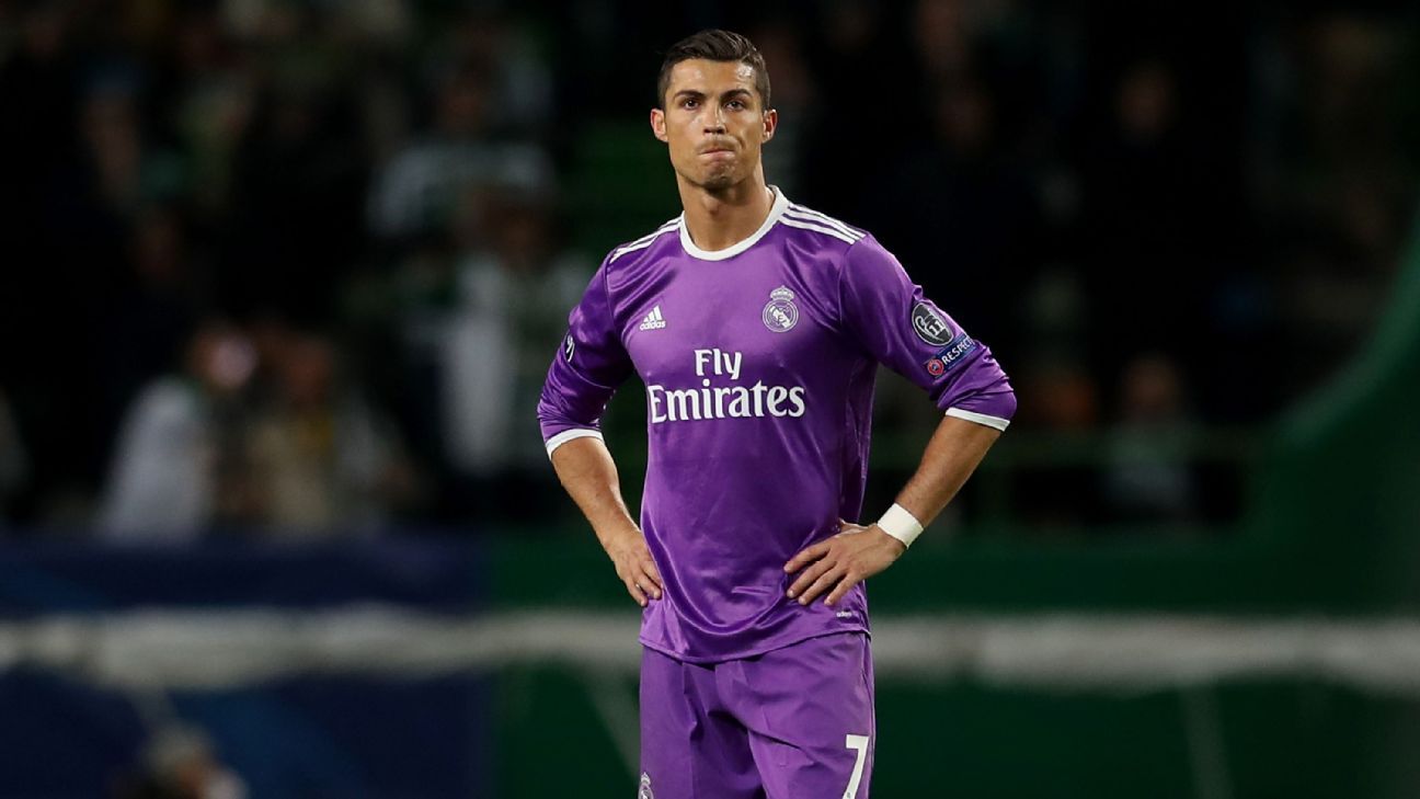 Real Madrid's Cristiano Ronaldo, white jersey, battles for the ball with  China's club team Guangzhou Evergrande's Feng Xiaoting during a friendly  match in Guangzhou, southern China's Guangdong province Wednesday, Aug. 3,  2011. (