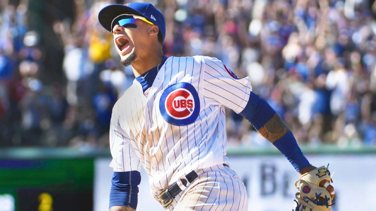 Javier Baez of the Chicago Cubs smiles at fans as he runs off the News  Photo - Getty Images