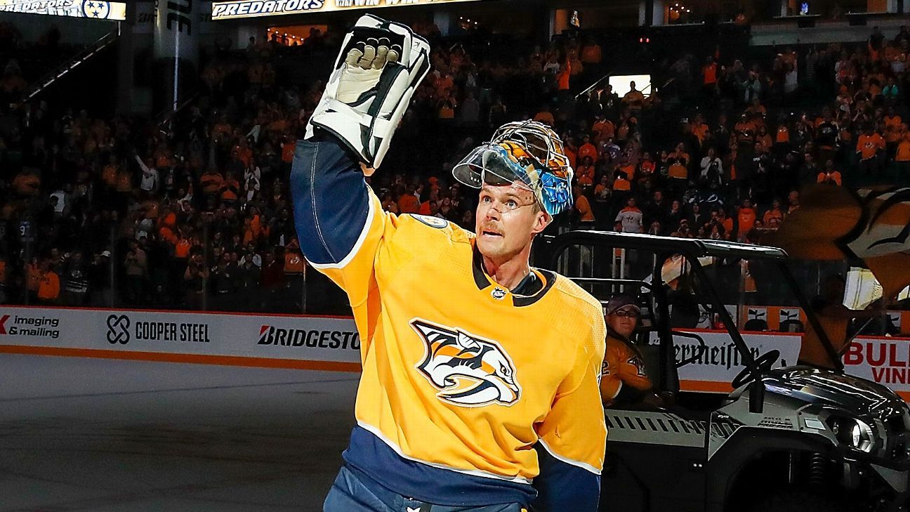 Former Nashville Predators goaltender Pekka Rinne, left, greets fans during  the unveiling ceremony of his statue before an NHL hockey game between the  Nashville Predators and the Seattle Kraken, Saturday, March 25