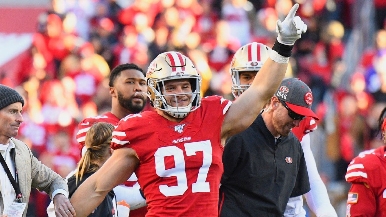 San Francisco 49ers first-round pick Nick Bosa, center, holds up a jersey  next to his mother Cheryl, left, and father John during an NFL football  news conference, Friday, April 26, 2019, in