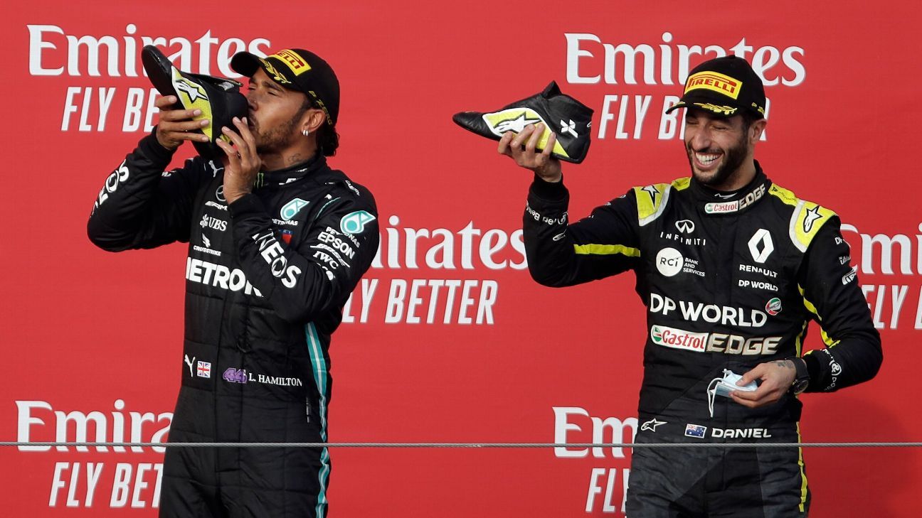 Lewis Hamilton sports wacky fluorescent trainers and a fedora