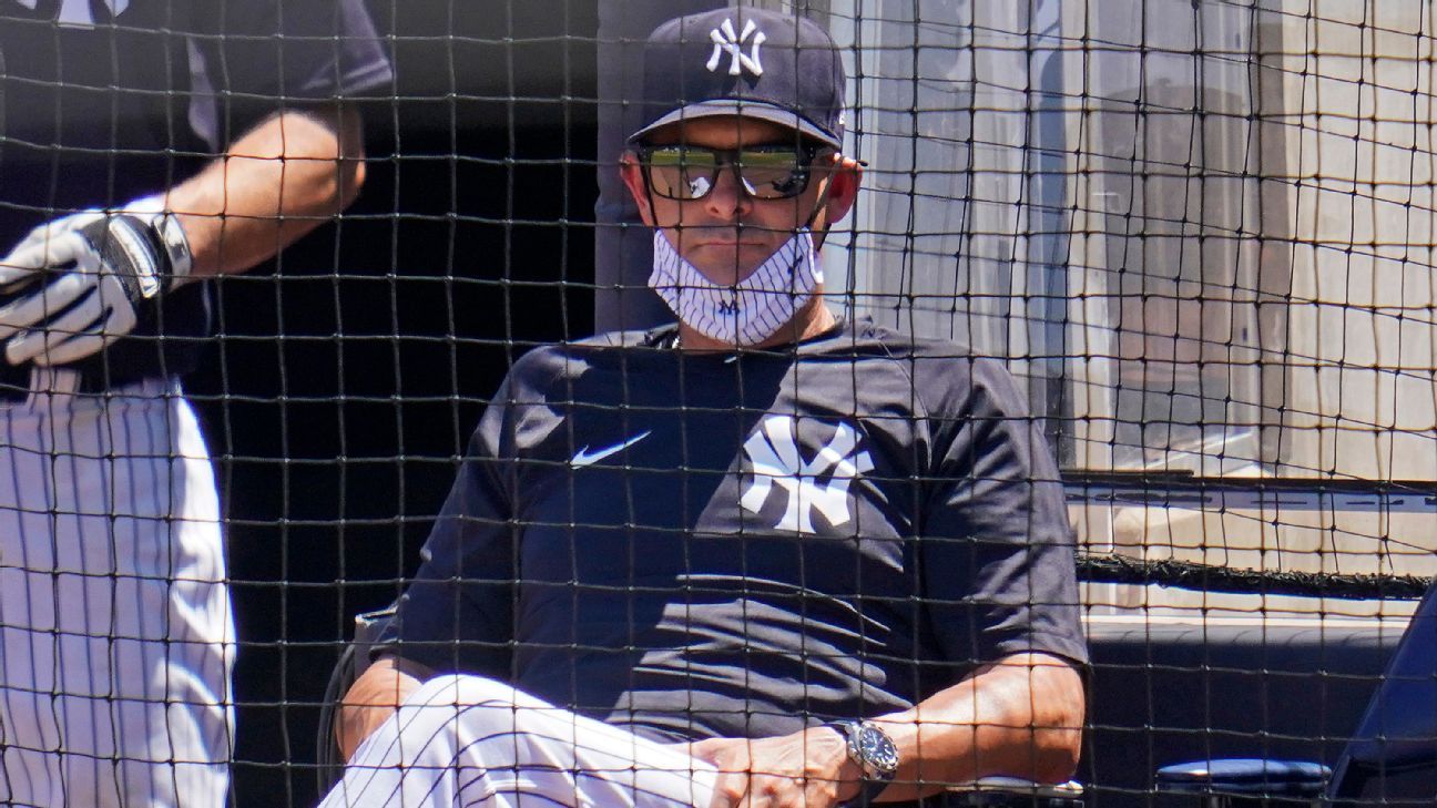 Baltimore, United States Of America. 11th July, 2018. New York Yankees  manager Aaron Boone (17) seems to be flexing his muscles in the dugout  prior to the game against the Baltimore Orioles