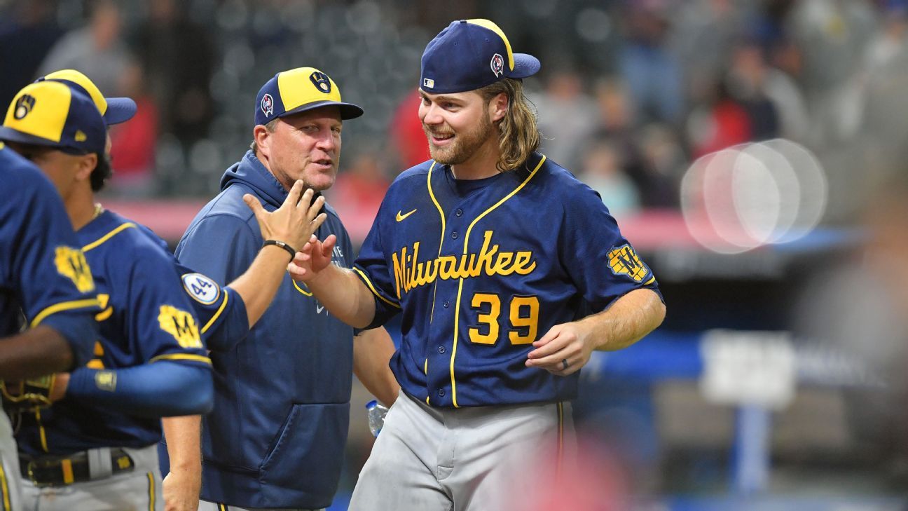 Milwaukee Brewers' Corbin Burnes adjusts his hair during the sixth