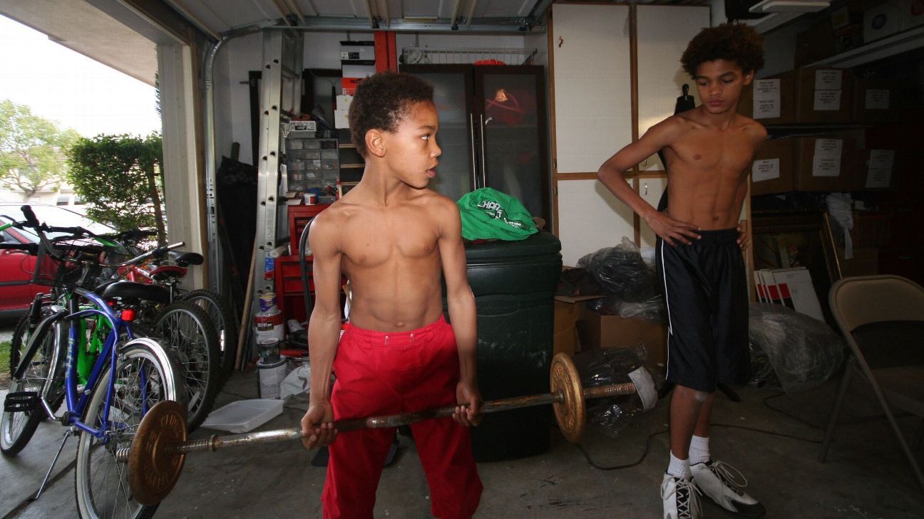 Lake Forest, USA. 30th Apr, 2021. Amon-Ra St. Brown (2nd from right) sits  on a couch between his mother Miriam Brown and brother Equanimeous St. Brown  during the NFL draft. Sitting next