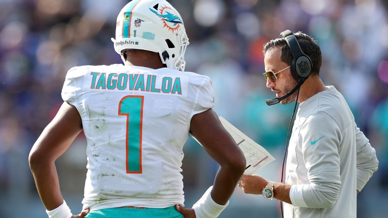 Tua Tagovailoa of the Miami Dolphins hands the ball off to Raheem