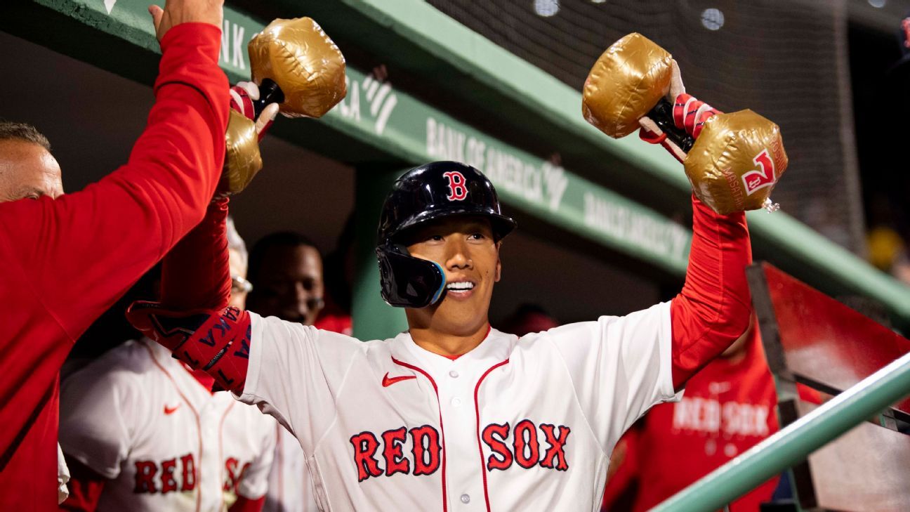 Trevor Story of the Boston Red Sox high-fives Rob Refsnyder after