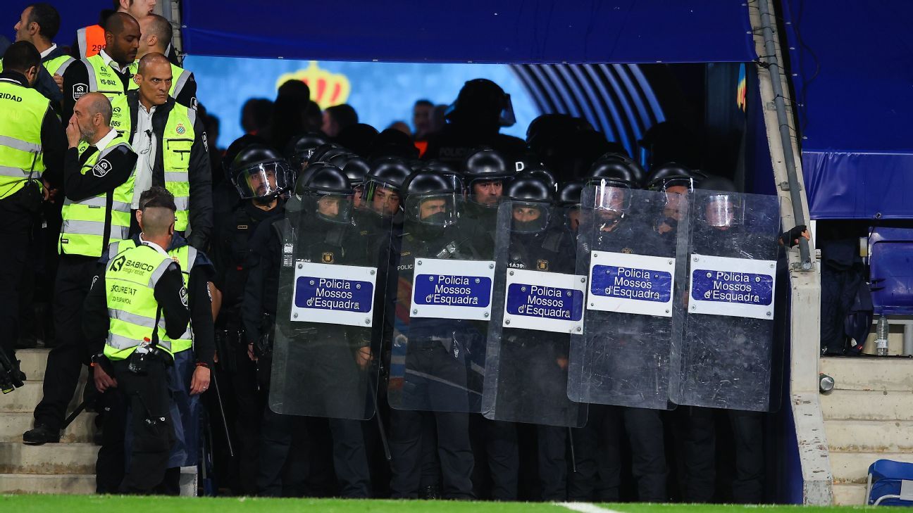 Riot cops shield Barca squad from pitch invaders