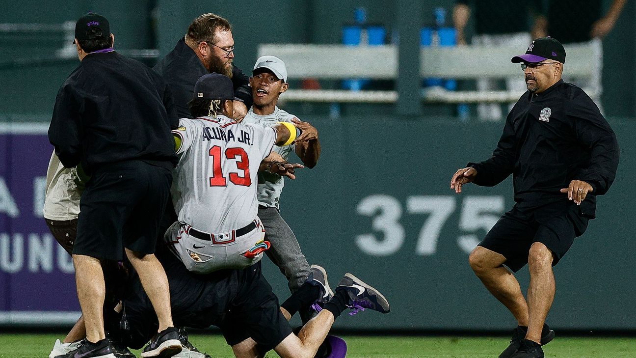 Atlanta Braves outfielder Ronald Acuña Jr. confronted by two fans