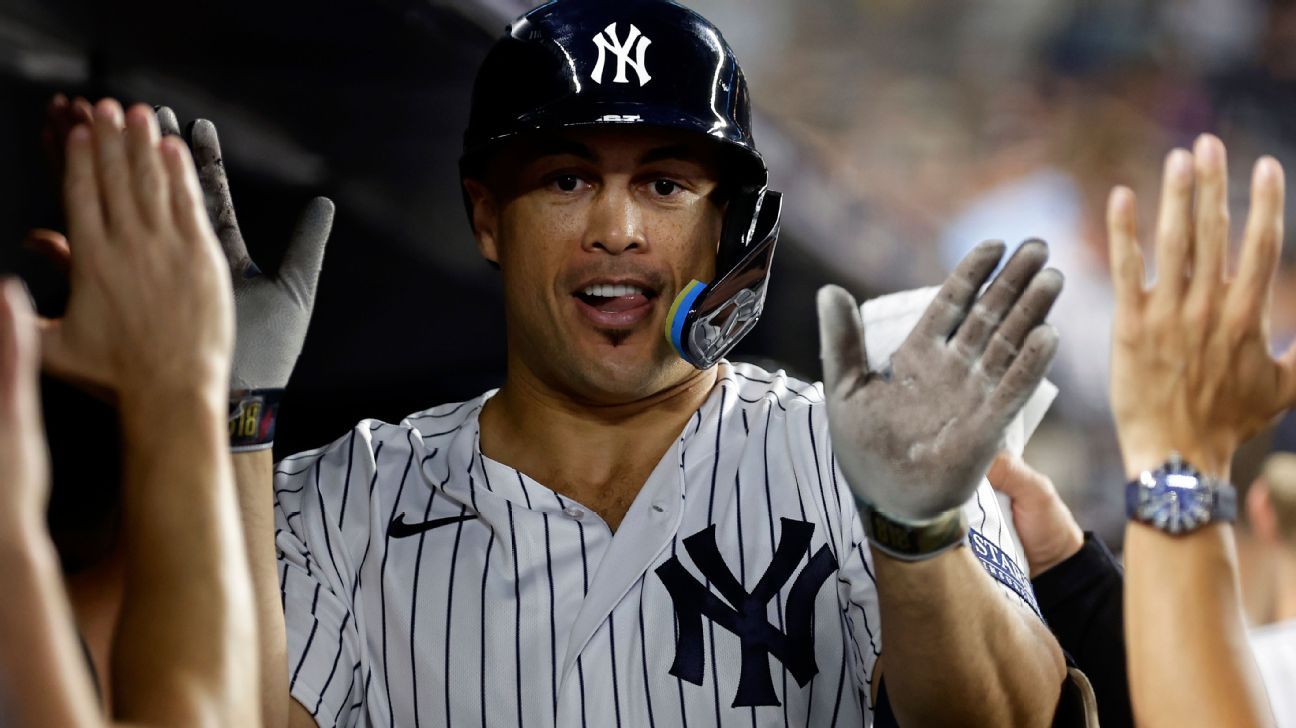 New York Yankees' Giancarlo Stanton watches his two-run home run