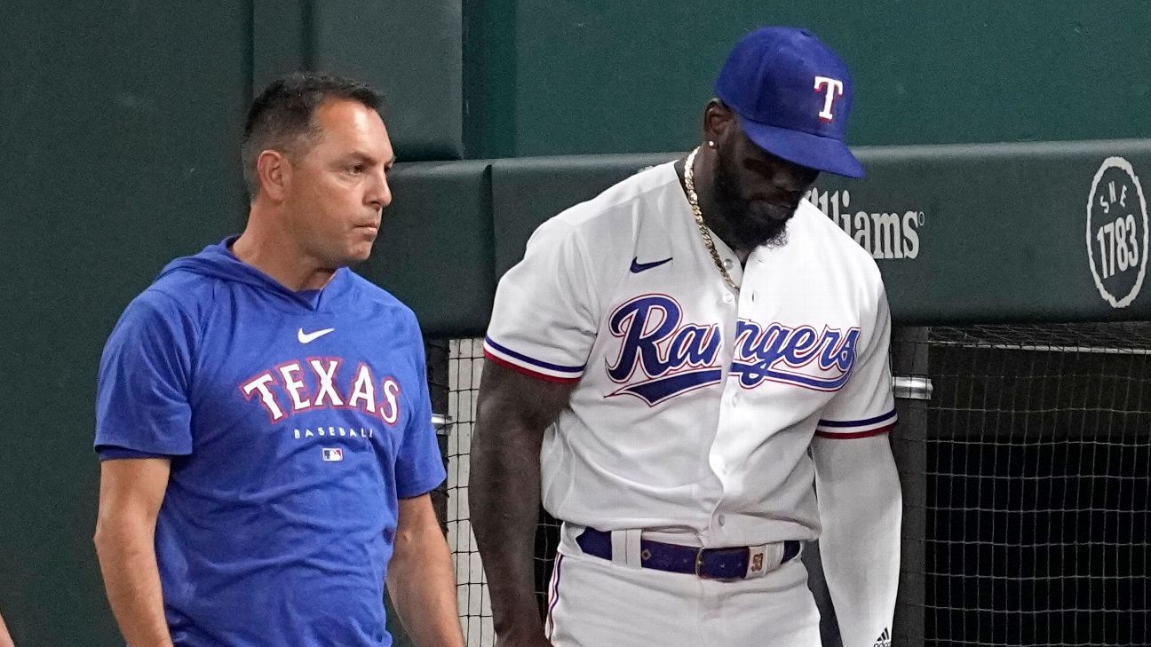 Adolis Garcia of the Texas Rangers fields a ball during the first